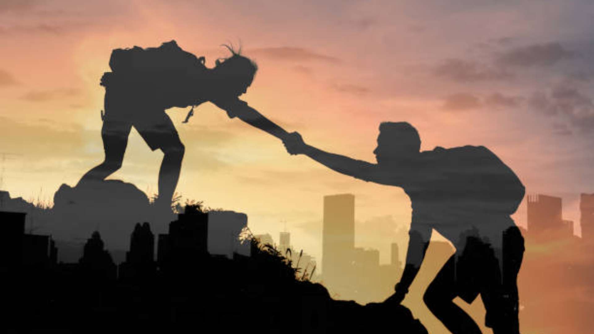 Person journaling in candlelight on wooden floor, surrounded by shadows