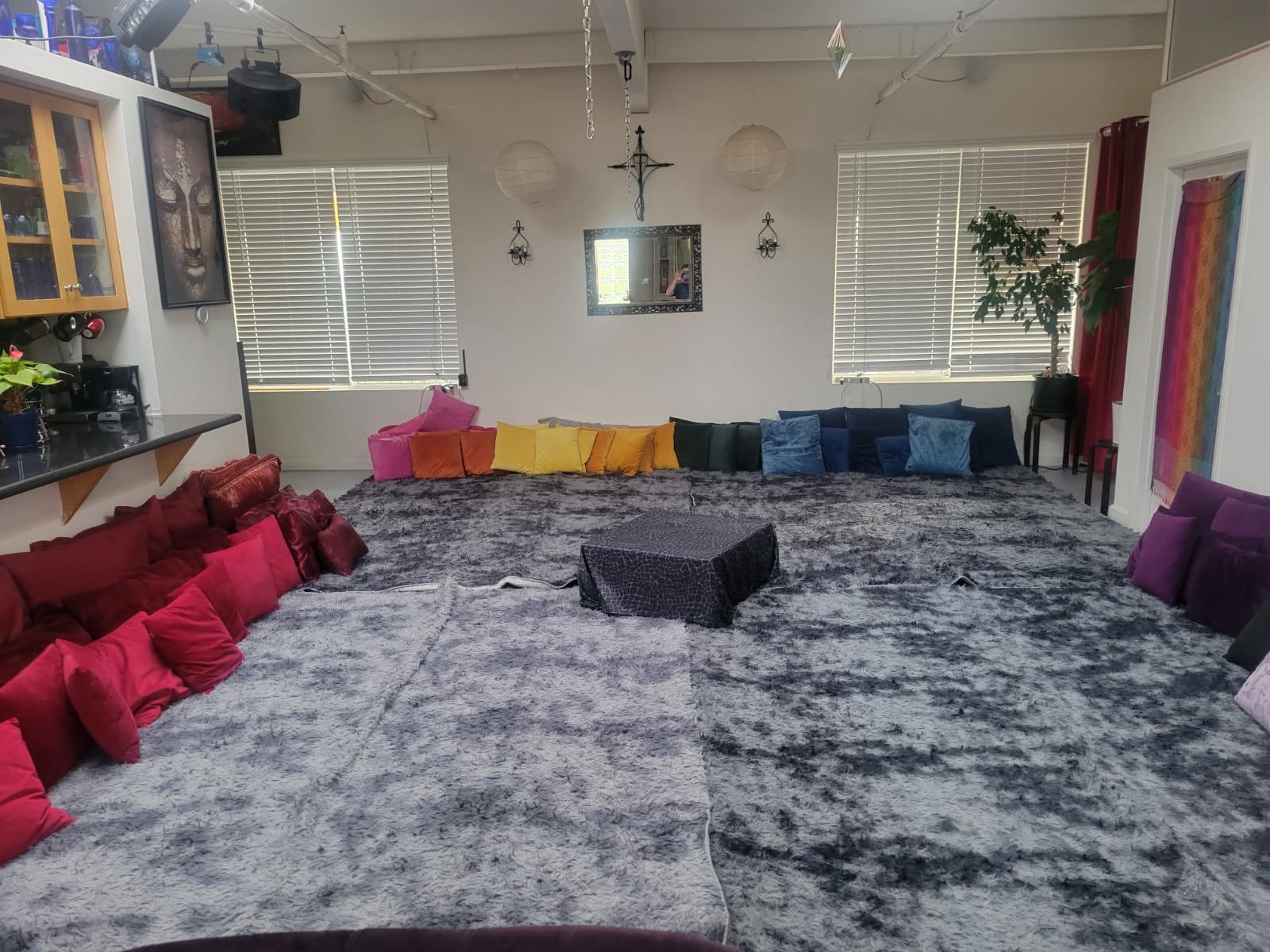 A peaceful and minimalist sacred space with soft lighting, meditation cushions, and spiritual symbols, ideal for home rituals.