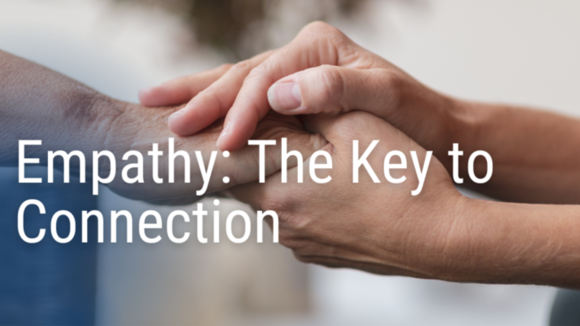 Two people holding hands with tenderness and support, symbolizing emotional connection and compassion.