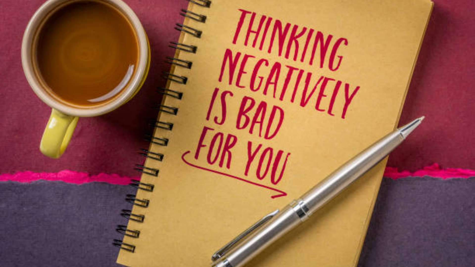 Person journaling with a CBT framework to transform negative thoughts.