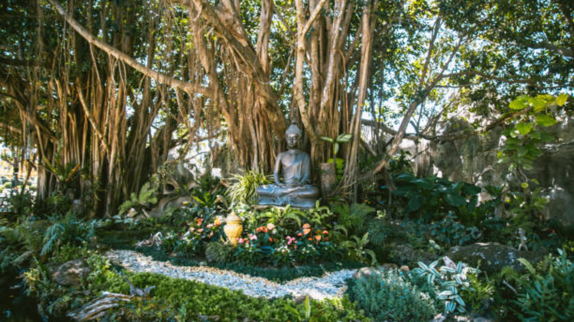 A peaceful soul garden sanctuary with meditation cushion, candle, and plants.