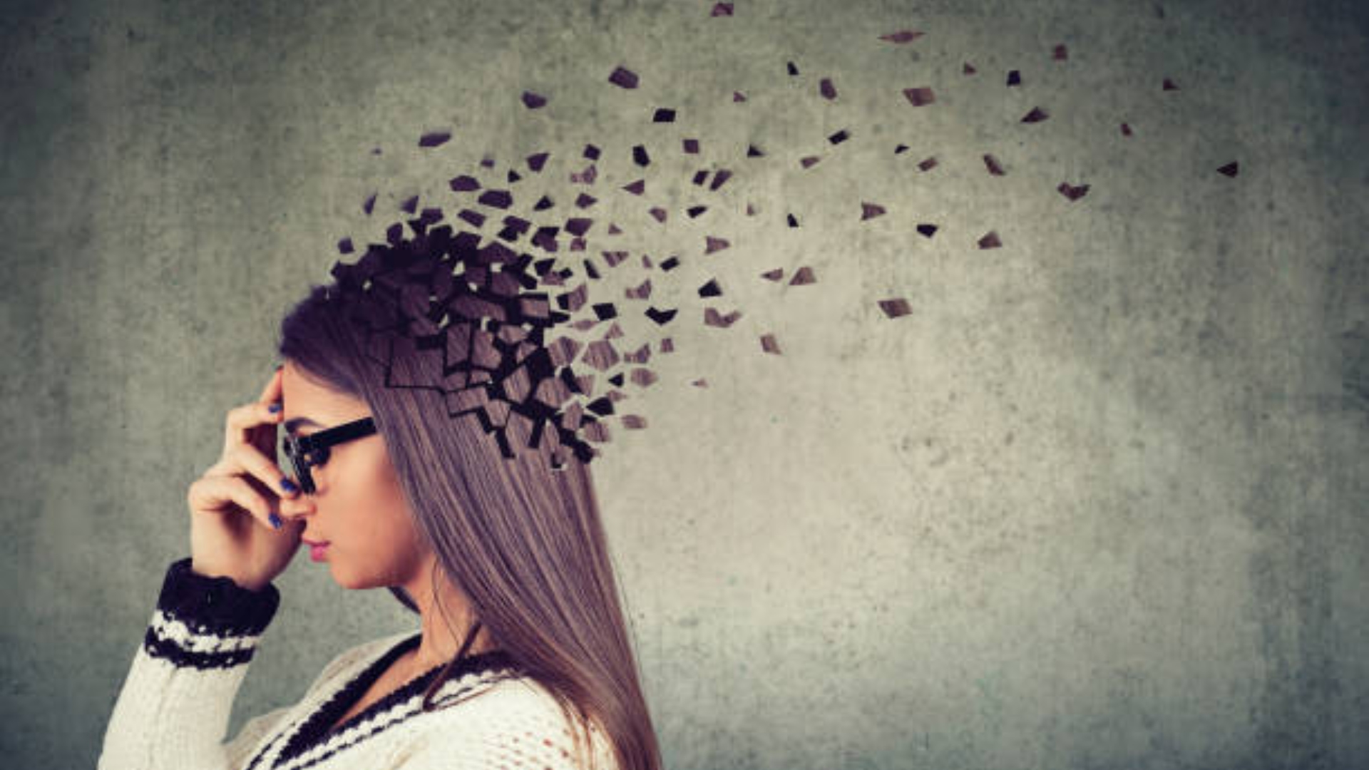 A person sitting under a tree with eyes closed, hand on heart, looking calm and reflective