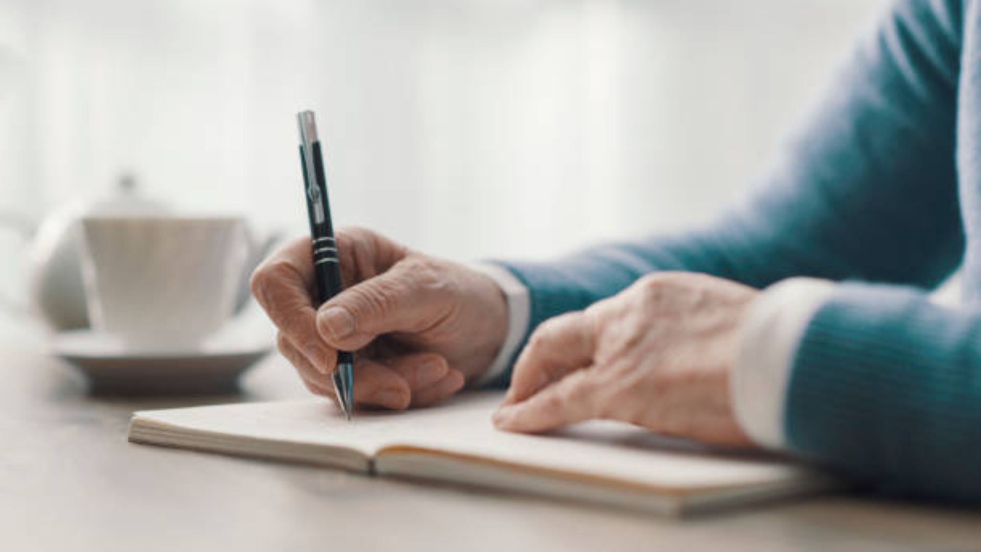 Handwriting a letter to your future self with a thoughtful expression.