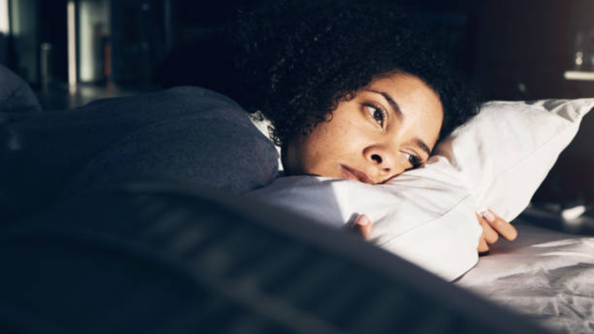 Peaceful bedroom scene with journal on nightstand for anxiety relief